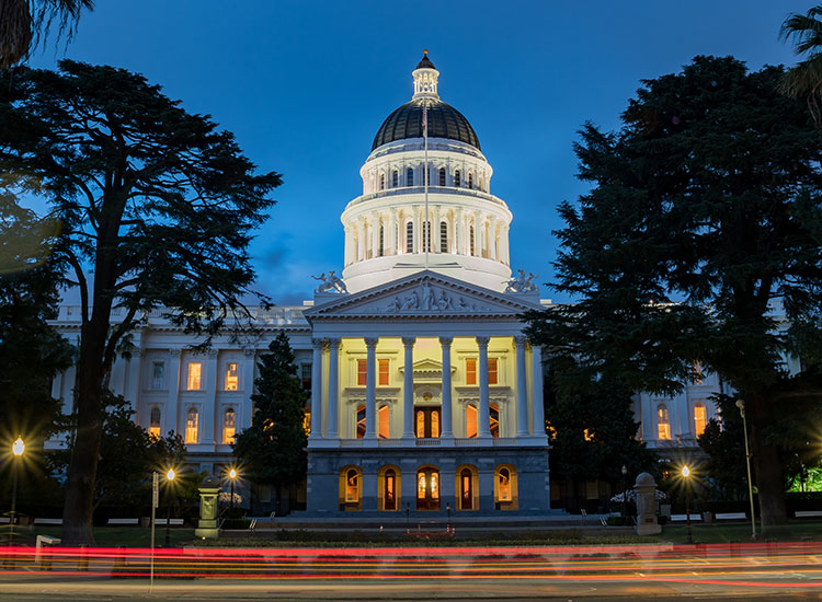 California State Capitol building with car breaklights streaking by